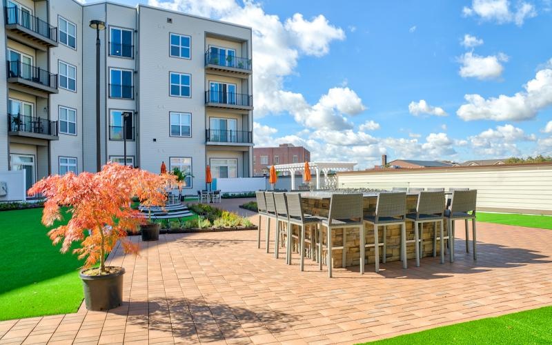 a brick patio with tables and chairs