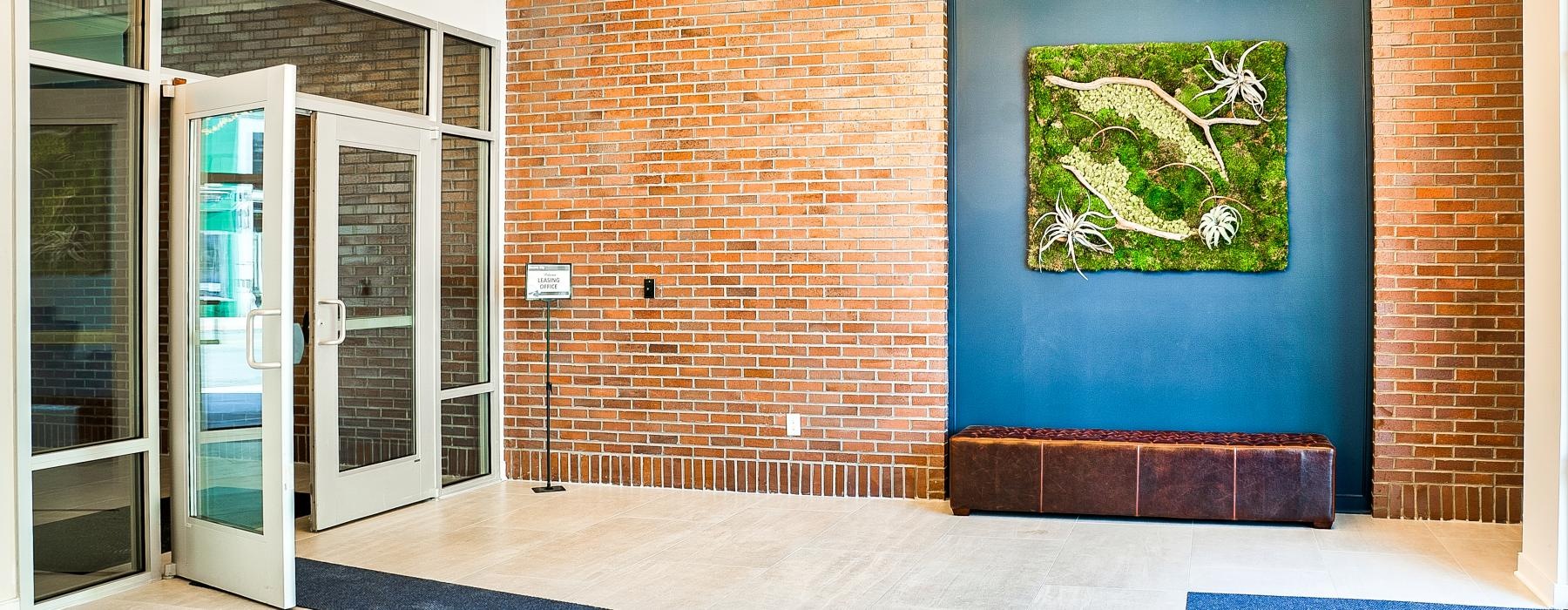 a room with a brick wall and a blue rug