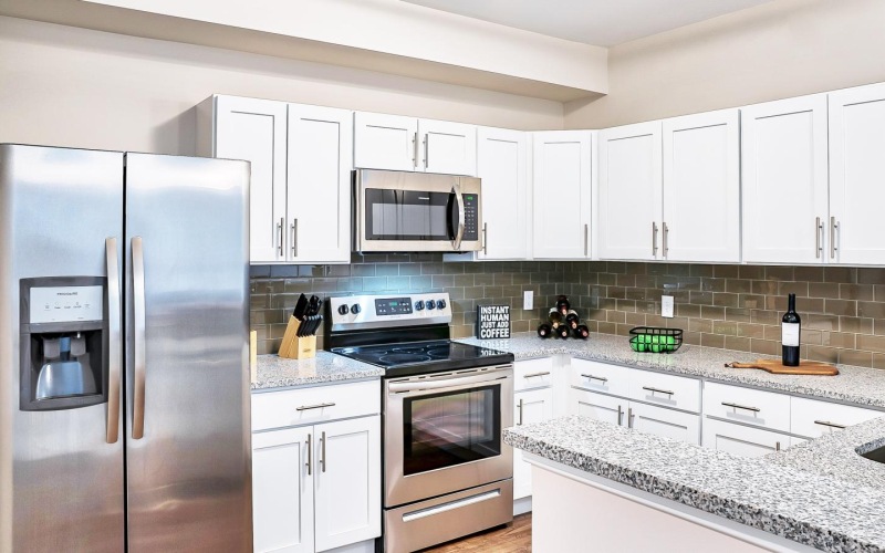 a kitchen with white cabinets