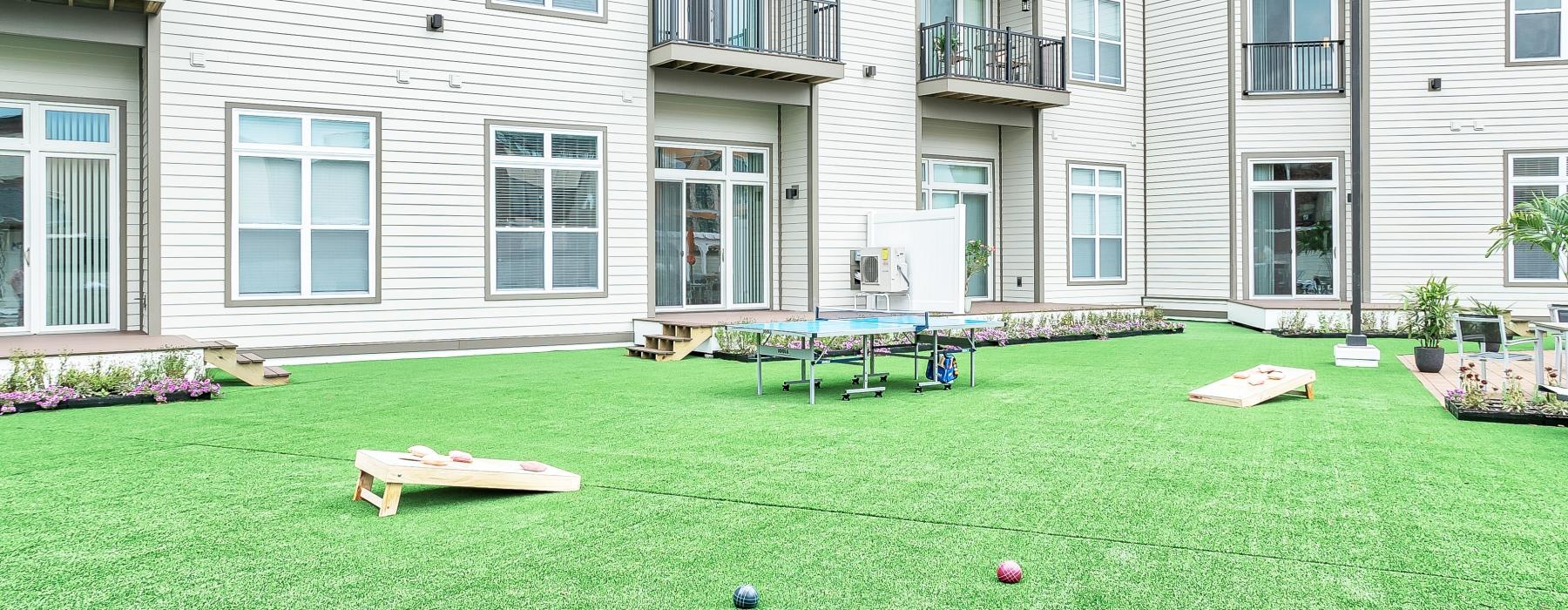 a building with a lawn and tables and games